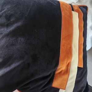 Decorative black and orange pillow cover.